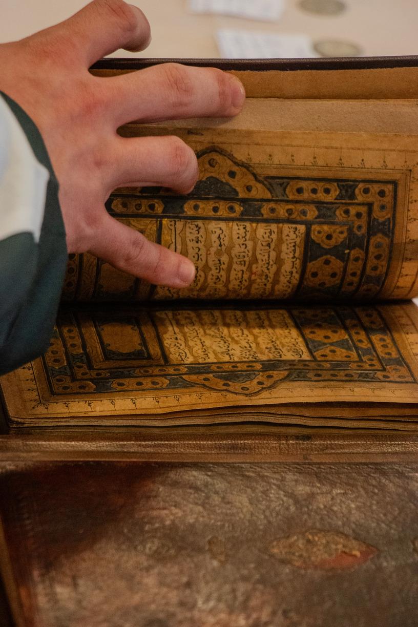 Old Qur'an being opened during TaqwaCon 2023